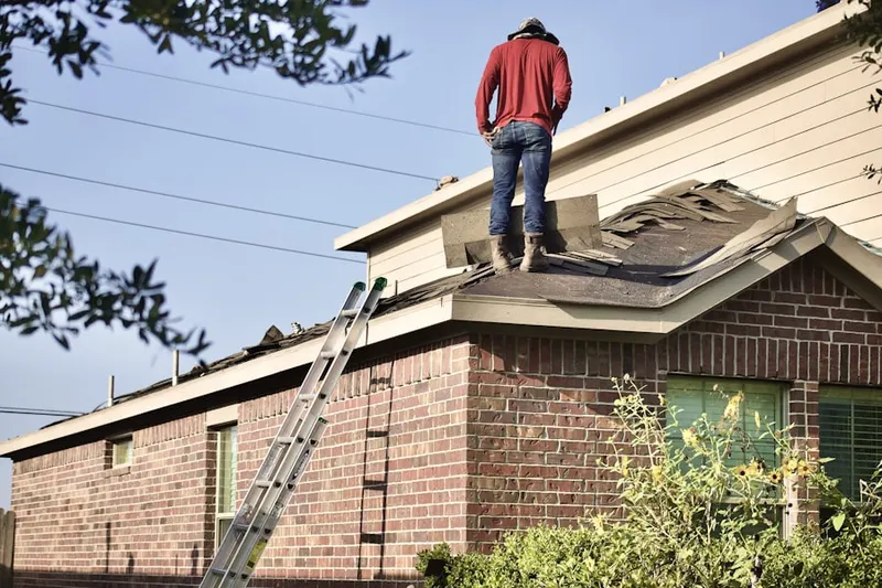 Professional roofer working on a residential roof in Montreat